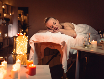 Warm towels and treatment essentials prepared for a spa visit