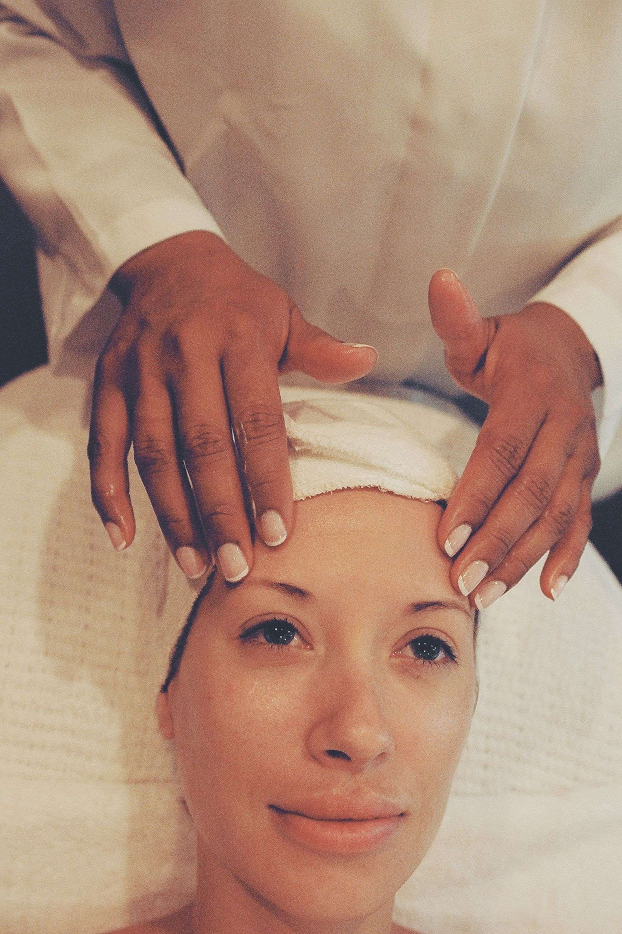 A guest's face during a calm, natural facial treatment