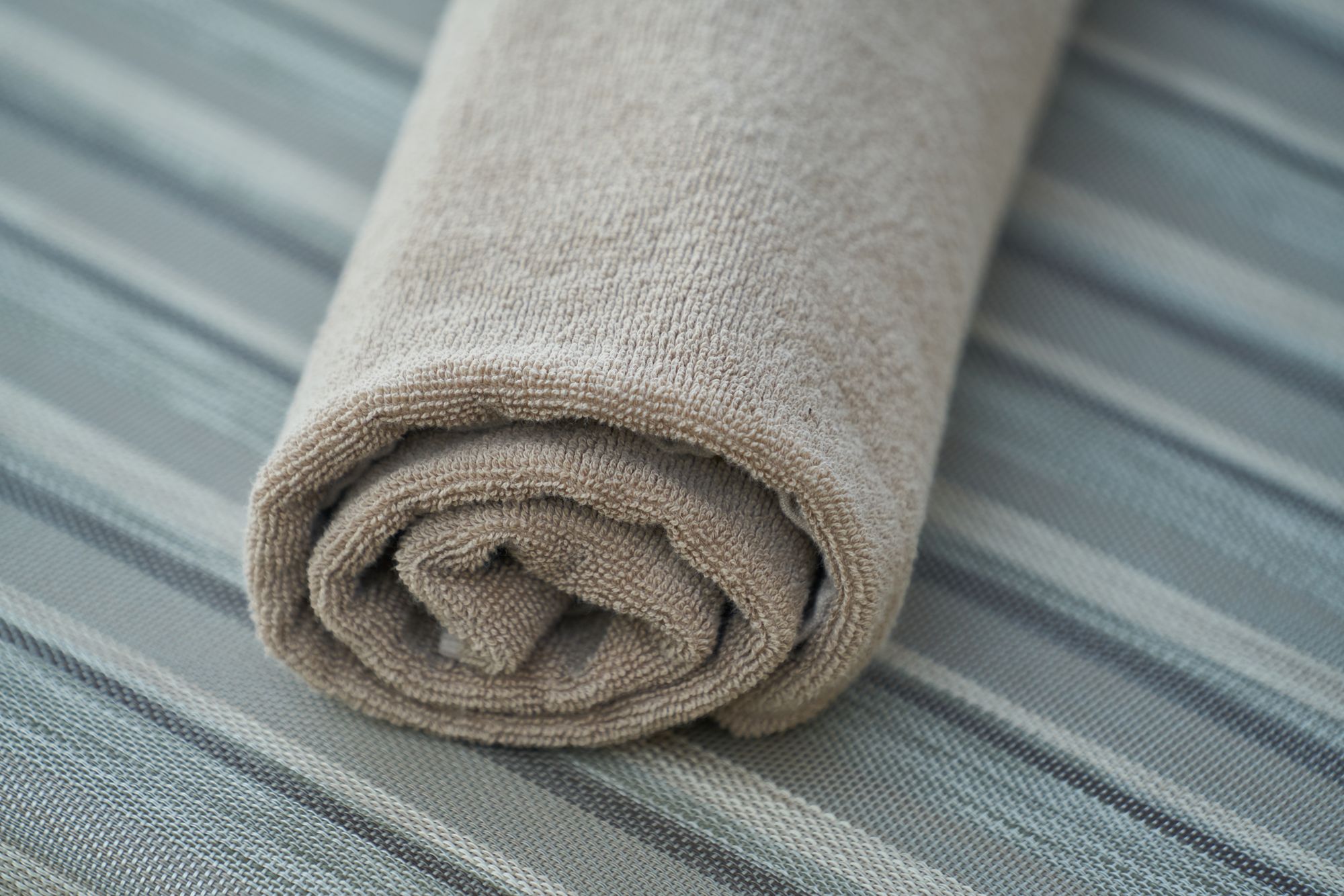 A neatly rolled spa towel, ready for a treatment